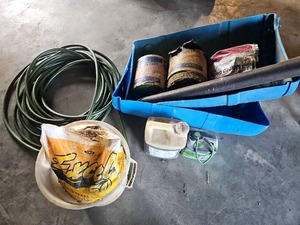 lot 56530 image: Set of 2 Baler Twine, Bag Of Calcium, Pesticide and other Chemicals, 2 halves of a 55 gallon drum, 50 Garden Hose