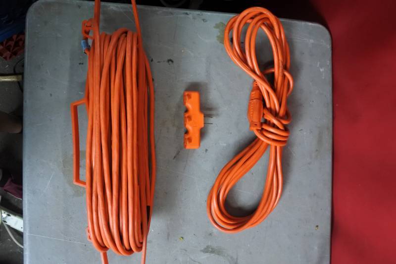 lot 10485 image: 2 Orange Extension Cords and An Orange Extension Adapter. (totes not included)