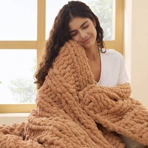 lot 5990 image: Bedsure Chunky Knit Throw Blanket for Couch - 100% Hand Knitted, 5.06 lbs GentleSoft Blanket with Giant Chenille Yarn for Bed Living Room Home Decor, Thick and Cozy, Orange, 50x60 Inches - Retail $60
