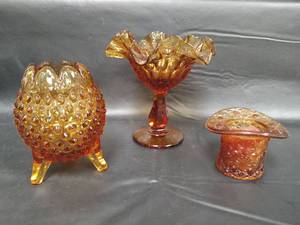 lot 242 image: Vintage Fenton Amber Collection - Hobnail 5 3 Footed Bud Vase, 6 Tall Thumbprint Compote and Daisy and Button Top Hat
