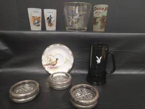 lot 270 image: Vintage Barware & Coaster Collection - Vtg Playboy Club Smoky Glass Stein, Gold Rimmed Mallard Duck Ice Bucket, Vtg Quantrells Raid Frosted Glass, Chisholm Trail Frosted Glass and More
