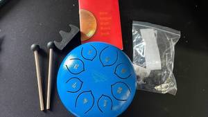 lot 17630 image: Steel Tongue Drum with Music Book - Retail $45