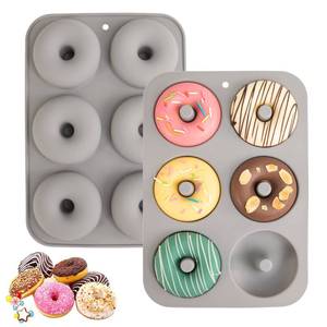 lot 2130 image: Aichoof Silicone Donut Mold for 6 Doughnuts, Set of 2. Food Grade LFGB Silicone Bagels Baking Pan, Non-Stick, Dishwasher Safe, Heat Resistant and Microwave Safe(Gray) - Retail $7