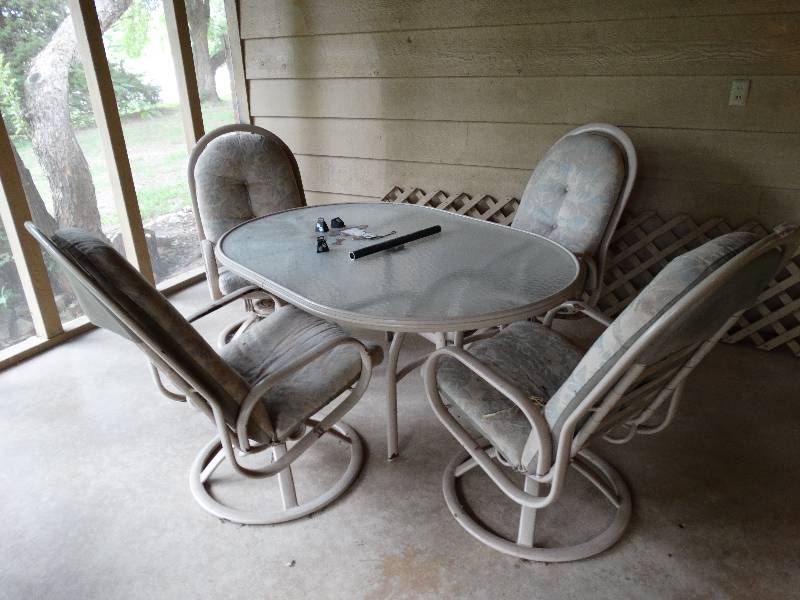 lot 13565 image: 5 Piece patio set with glass table and 4 chairs.