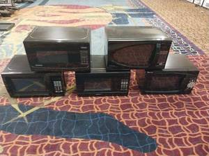 lot 7444 image: 1 Microwave - StylesModels Vary (Magic Chef, Seasons, Walmart & Danby Models) (only 1 microwave included in each lot. Group photo is to represent size and models only)