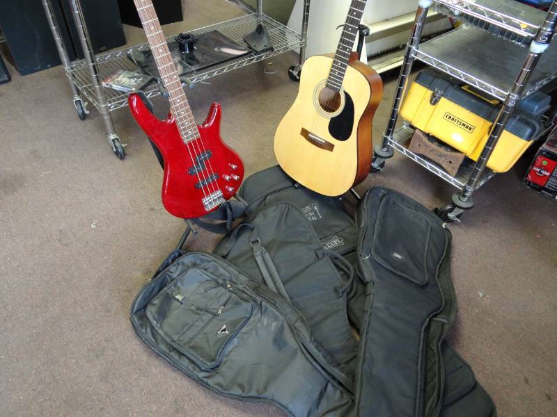 lot 1490 image: Ibanez Sound gear Electric Base Guitar and Jasmine Guitar, 2 Stands and 4 Black Cases