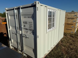 lot 1056 image: Unused 10 foot Security Container with window and walk through door