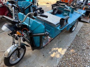 lot 1461 image: Unused 2025 IRET13 Electric Tricycle-I call these Tuk Tuks and they are really fast and useful, dump bed and suspension Assembled but does have damage, will need electrical work