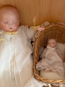 lot 607 image: Antique Baby Doll, Marked on Back of Head (w note from owner) and a 5 Baby Doll in a Bassinet