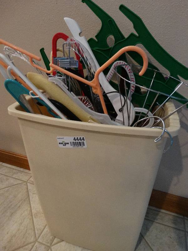 lot 4444 image: Small trash can full of hangers.