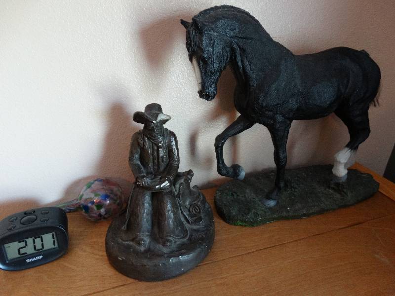 lot 4468 image: Cowboy statue broken hat, horse statue, & clcok.