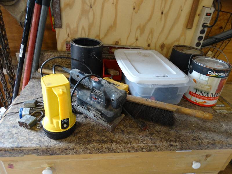 lot 4612 image: Lot of black & decker sander, flashlight, locks, paint cans & more.