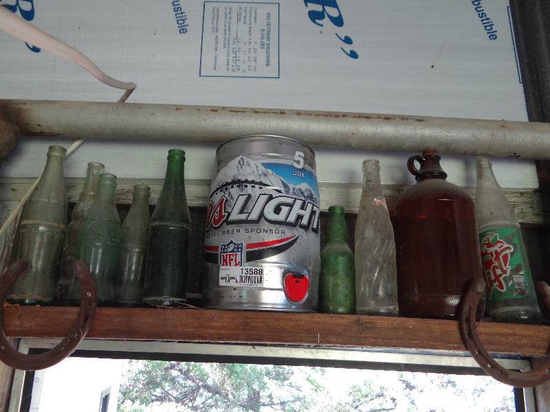 lot 13588 image: Lot of glass bottles, horse shoe, coors light container.