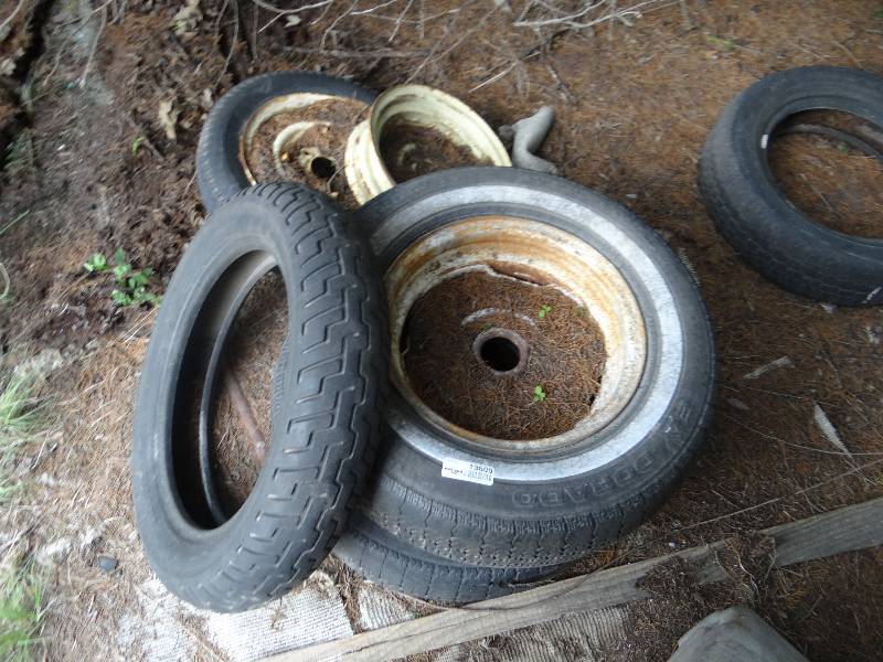 lot 13609 image: Assorted tires, rims and a trash can.