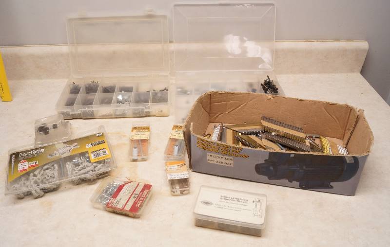 lot 1053 image: Lot of nail gun nails, anchor screws and other hardware, hooks and eyes