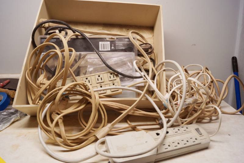 lot 1023 image: Box of power strips and heavy duty extension cords