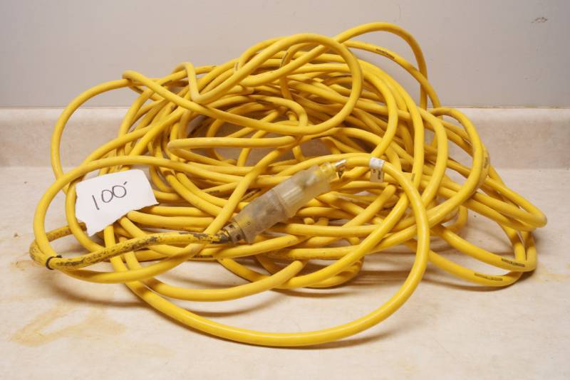 lot 1030 image: Nice, heavy Yellow Extension Cord - Believed to be 100