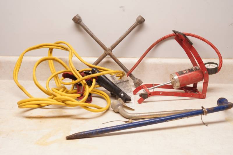 lot 1044 image: Auto Hazard Lot - Jumper Cables, Tire Irons, Foot Air Pump, new rain poncho