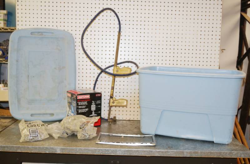 lot 1212 image: Pneumatic Air Gun, Lot of Ceiling Tile Hangers, Shop Vac Filter (new), a blue storage tub and more.