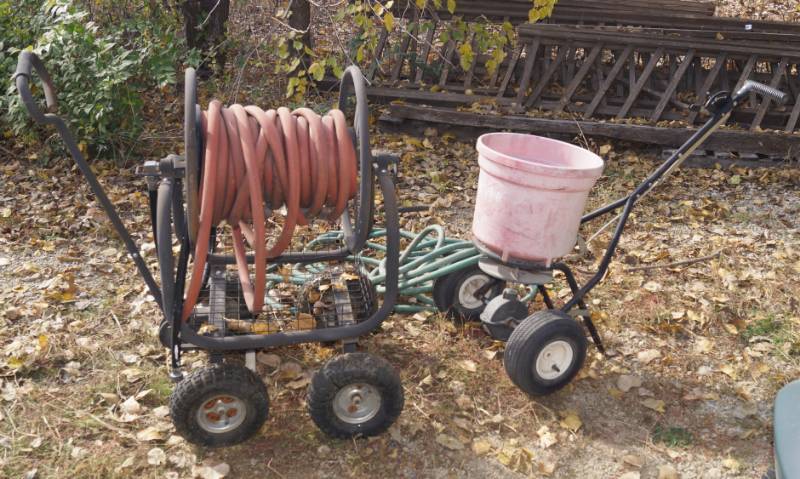 lot 1222 image: Hose reel w hose, lawn spreader and extra hose