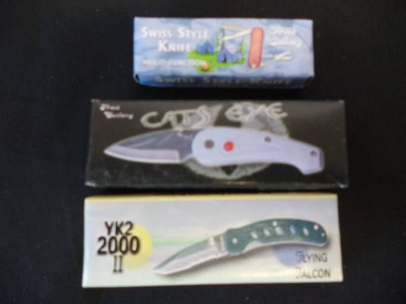 lot 2486 image: New in box Swiss Style Multi-function Knife. New in box Frost Cutlery Cats Eye Knife. New in box Flying Falcon YK2 2000 II Knife.