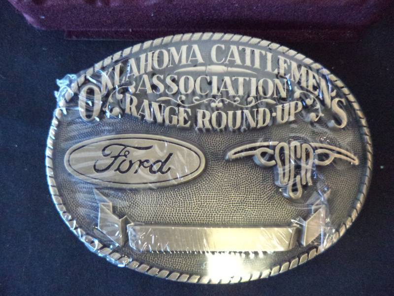 lot 2593 image: Oklahoma Cattlemens Association, Solid Brass Belt Buckle