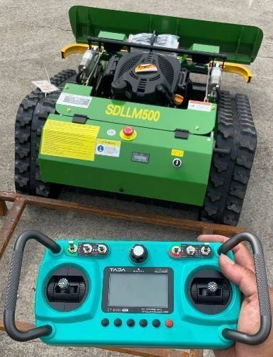 lot 5159 image: Unused Remote Control Lawn MowerBrush Cutter w Snow ShovelBlade SDLANCH SDLLM500 - ShovelBlade Has Layered Rubber At The Bottom To Protect Concrete, Asphalt, Etc.