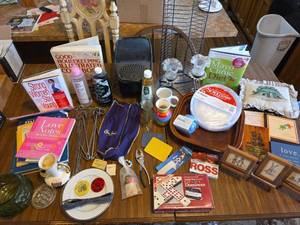 lot 680 image: Contents- Home Decor, Plastic Plates, Books, Glassware,  Lamp Oil, DVD Stand, Jumbo Dominoes, and More