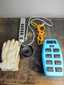 lot 1056 image: Surge Protectors, Extension Cord, Mens L Leather Gloves and Roll of Velcro