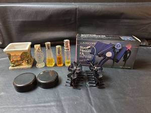 lot 277 image: Blood Pressure Kit, 2 Hair Clips, and Glass Perfume Bottles