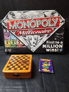 lot 285 image: Monopoly Millionaire Board Game Bundle with Wooden Checkers Chest and Garfield Cards