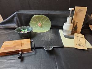 lot 347 image: The Pampered Chef Food Chopper, Cutting Boards, Lily Pad Splatter Guard, Crock Apple Baker, and Cheese Cutting Board