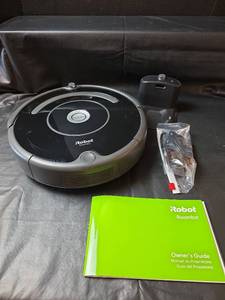 lot 523 image: iRobot Roomba Robot Vacuum with Charging Station Powers On