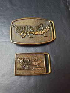 lot 595 image: 1983 & 1989 Grasshopper Lawn Mower Promotional Belt Buckles