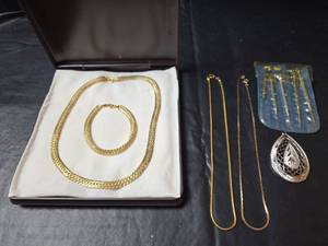lot 633 image: Gold Toned Herringbone Chain Necklace and Bracelet, 2 Gold Toned Necklaces,  Silver Toned Pendant, and Jewelers Tool Set