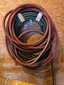 lot 5055 image: Garden Hose and Rack (bring Hex to remove rack from wall)