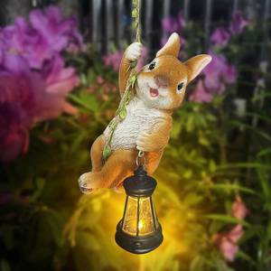 lot 2324 image: Joliyoou Solar Light Outdoor Statues, 6.9 H Resin Rabbit Climbing On A 23.6in L Vine with LED Lantern, Waterproof Hanging Bunny Figurine with Hook for Easter Yard Garden Wall Balcony Tree Decoration - Retail $18