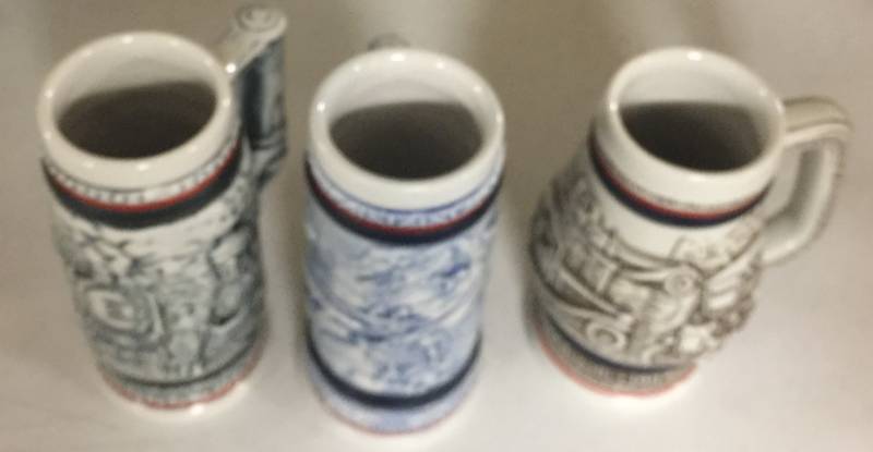 lot 1228 image: Three Early to Mid 1980s Mini Avon Collector 5 Inch Steins Train Engine Airplanes Cars