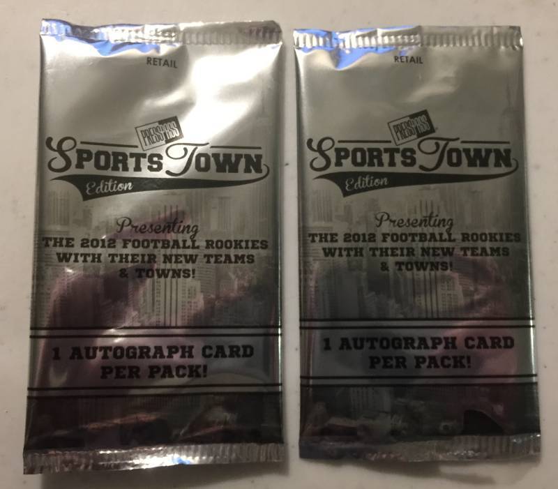 lot 1073 image: Two Sealed 2012 Press Pass Sportstown Football Card Packs with Two Guaranteed Rookie Autographs Russell Wilson Luck