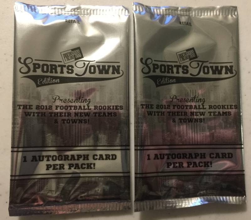 lot 1074 image: Two Sealed 2012 Press Pass Sportstown Football Card Packs with Two Guaranteed Rookie Autographs Russell Wilson Luck