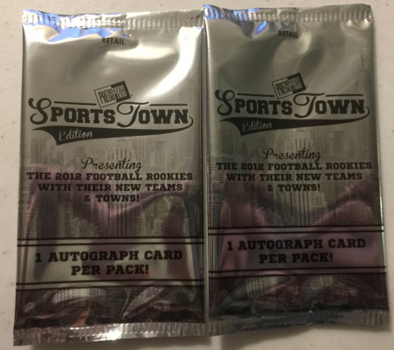 lot 1077 image: Two Sealed 2012 Press Pass Sportstown Football Card Packs with Two Guaranteed Rookie Autographs Russell Wilson Luck