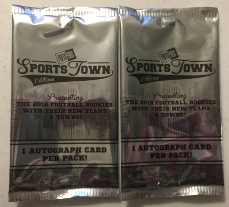 lot 1079 image: Two Sealed 2012 Press Pass Sportstown Football Card Packs with Two Guaranteed Rookie Autographs Russell Wilson Luck