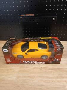 lot 42541 image: Champion Racing RC Car - Yellow Sports Car Model - Retail $15