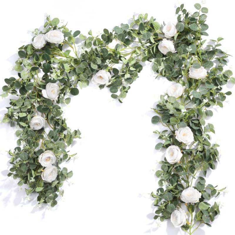 lot 1026 image: 2 Pack Eucalyptus Garland with Roses, White Flower Garland Artificial Silk Floral Vines Eucalyptus Leaves Vines Decor. Retail $24.98