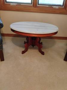 lot 929 image: Oval Shaped Coffee Table with Marble Top.  19 x 34 x 25. Located UPSTAIRS