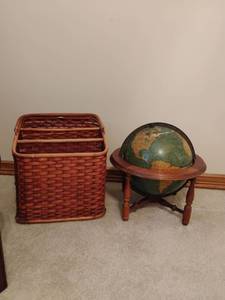 lot 931 image: Wicker Magazine Holder and a Small World Globe.  Globe is approximately 14 x 16. Located UPSTAIRS