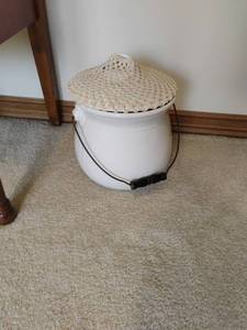 lot 945 image: Chamber Pot with handmade crochet silencer so not to disturb when used at night. 12 inches tall. Located UPSTAIRS