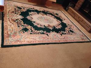 lot 950 image: Area Rug.    119 x 95.  Rug looks black in pictures but it is actually dark green Located DOWNSTAIRS