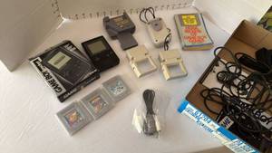 lot 1005 image: Nintendo Game Boy Pocket, 3 games, Game Jenie, Nuby Game Light, book and power supply