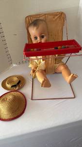 lot 1010 image: Vintage doll high chair with doll and 2 hats